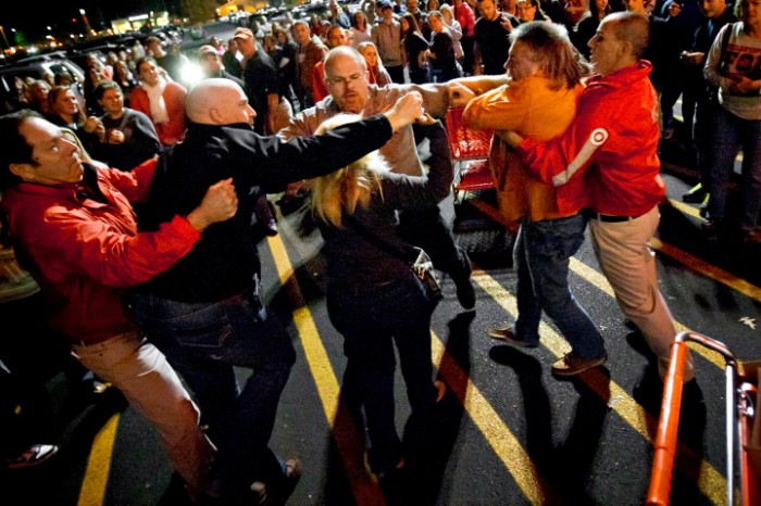 Security guards break up a fight between on Black Friday 2012.